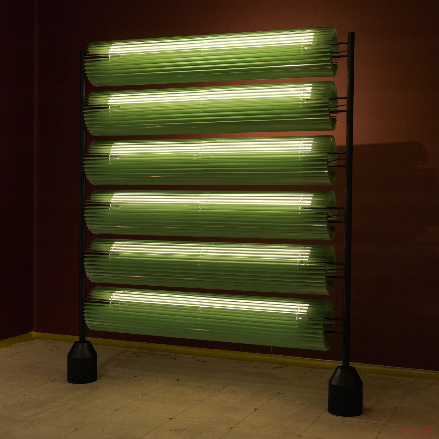 The partition at an angle, lighting the maroon walls