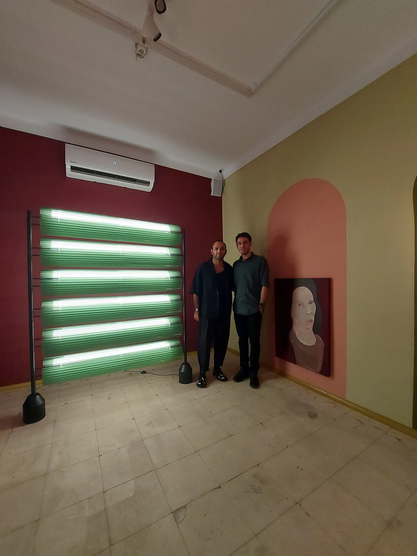 Visitors beside the glowing partition