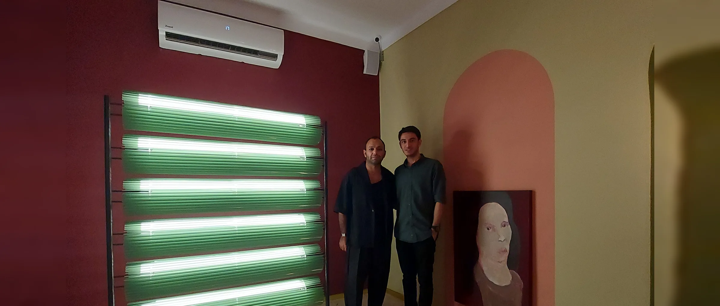 The glowing Kekera partition beside its makers at Abar Studio's gallery