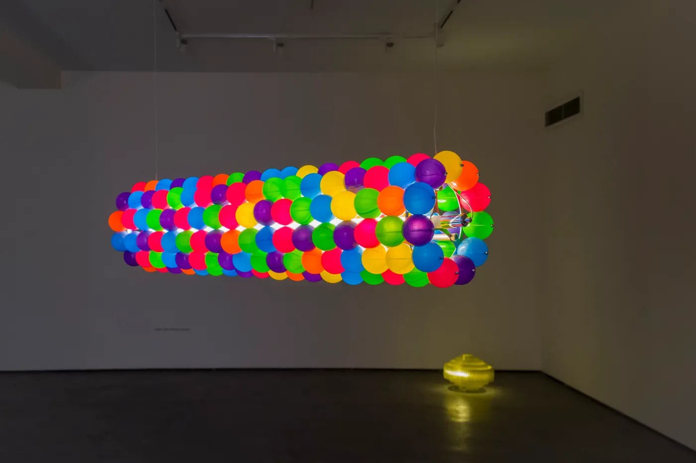 Tooper's colourful cylinder floating above the yellow Dot Nut