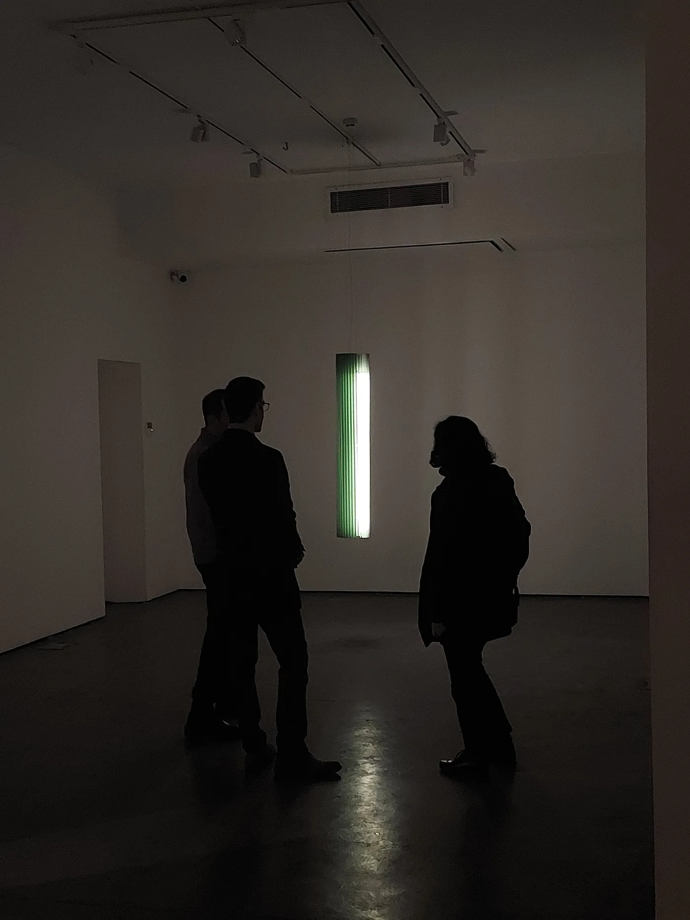Visitors beside Keker's green glow