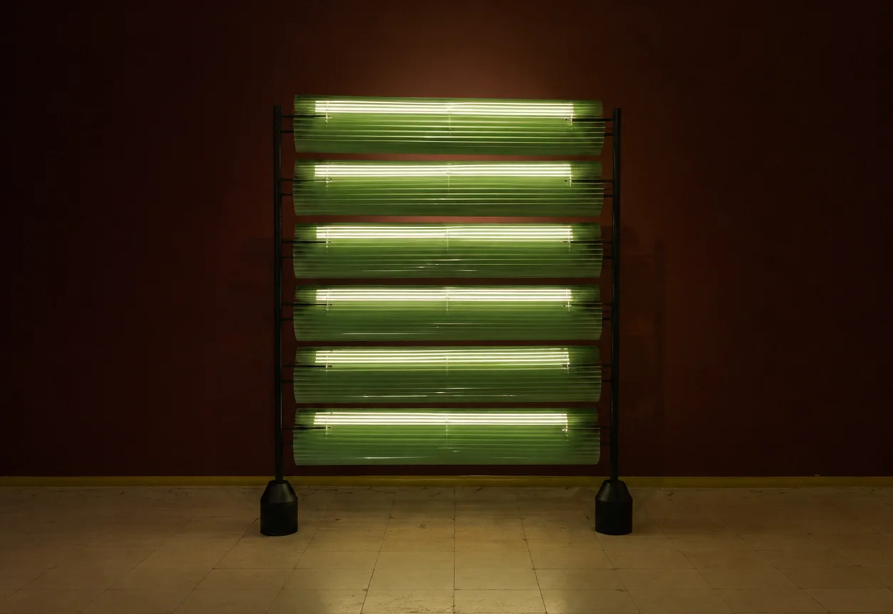 The Kekera partition glowing green against the dark walls of Abar Studio's gallery