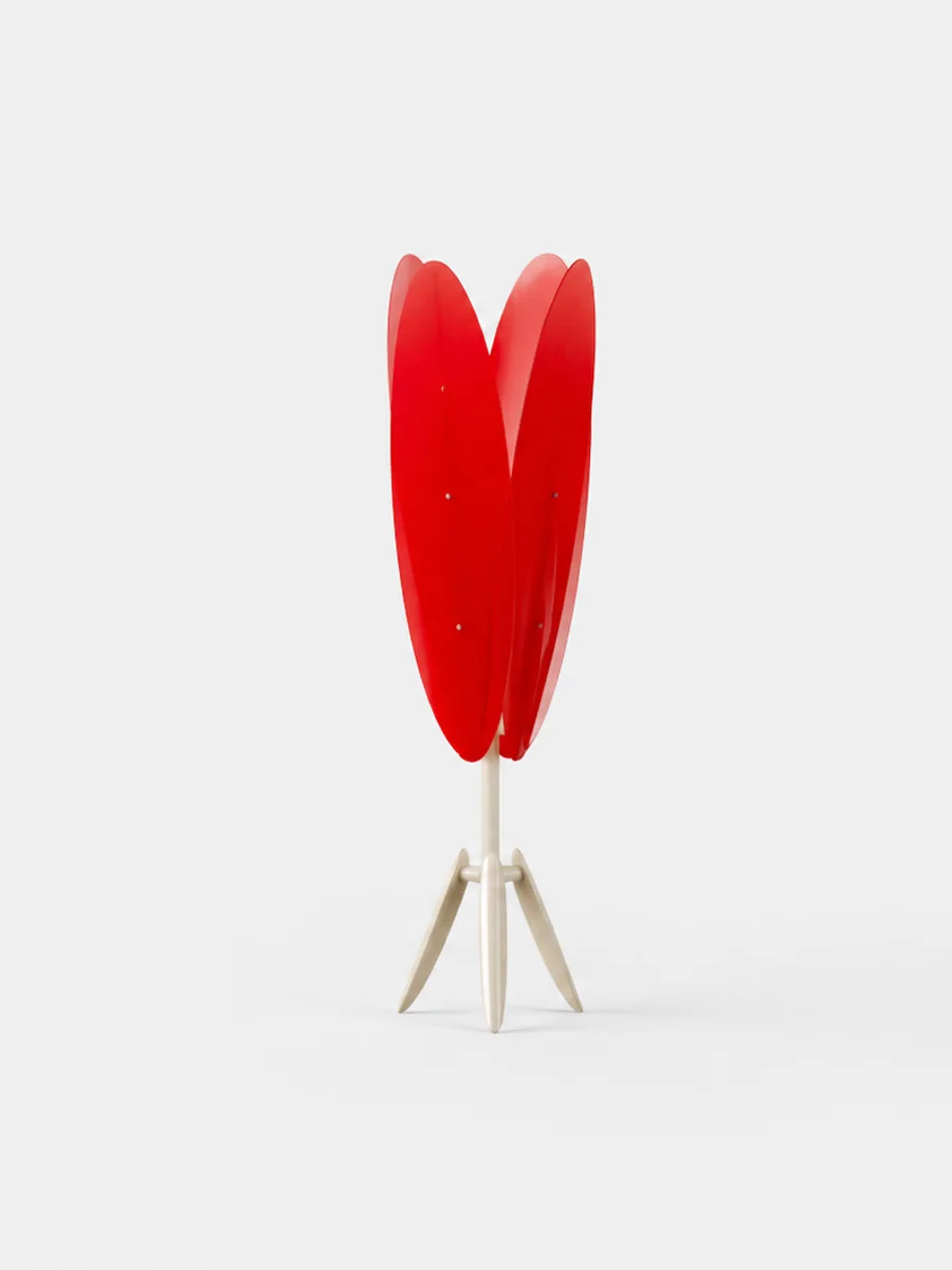 A single red tulip lamp of the procession, standing on cream Dot legs