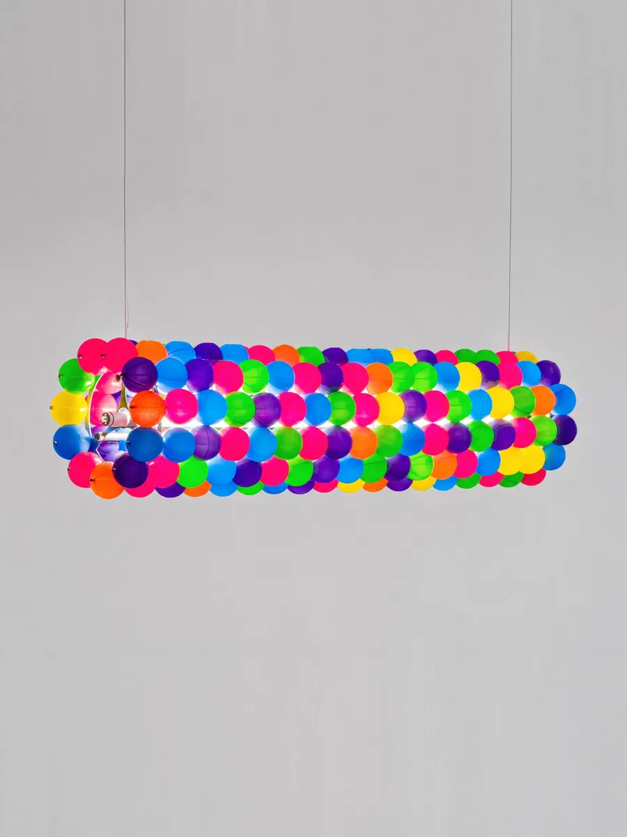 Tooper pendant lamp — a suspended cylinder of multicoloured play balls, lit from within