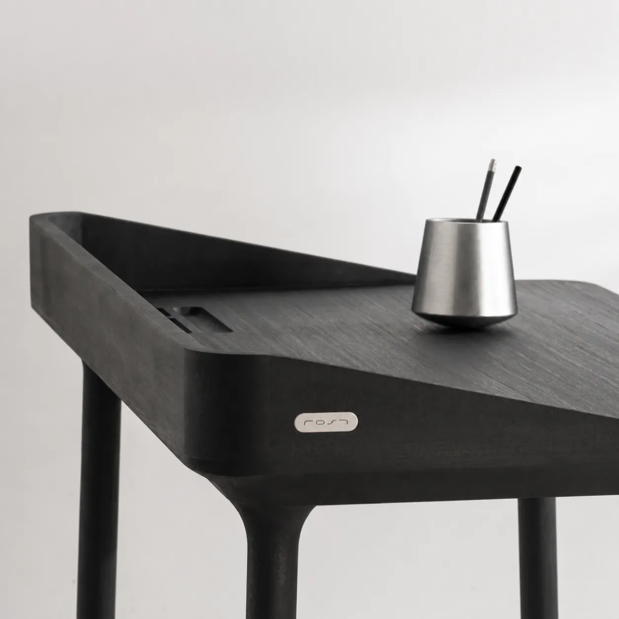 Desk Balance in steel, holding pencils on a dark desk