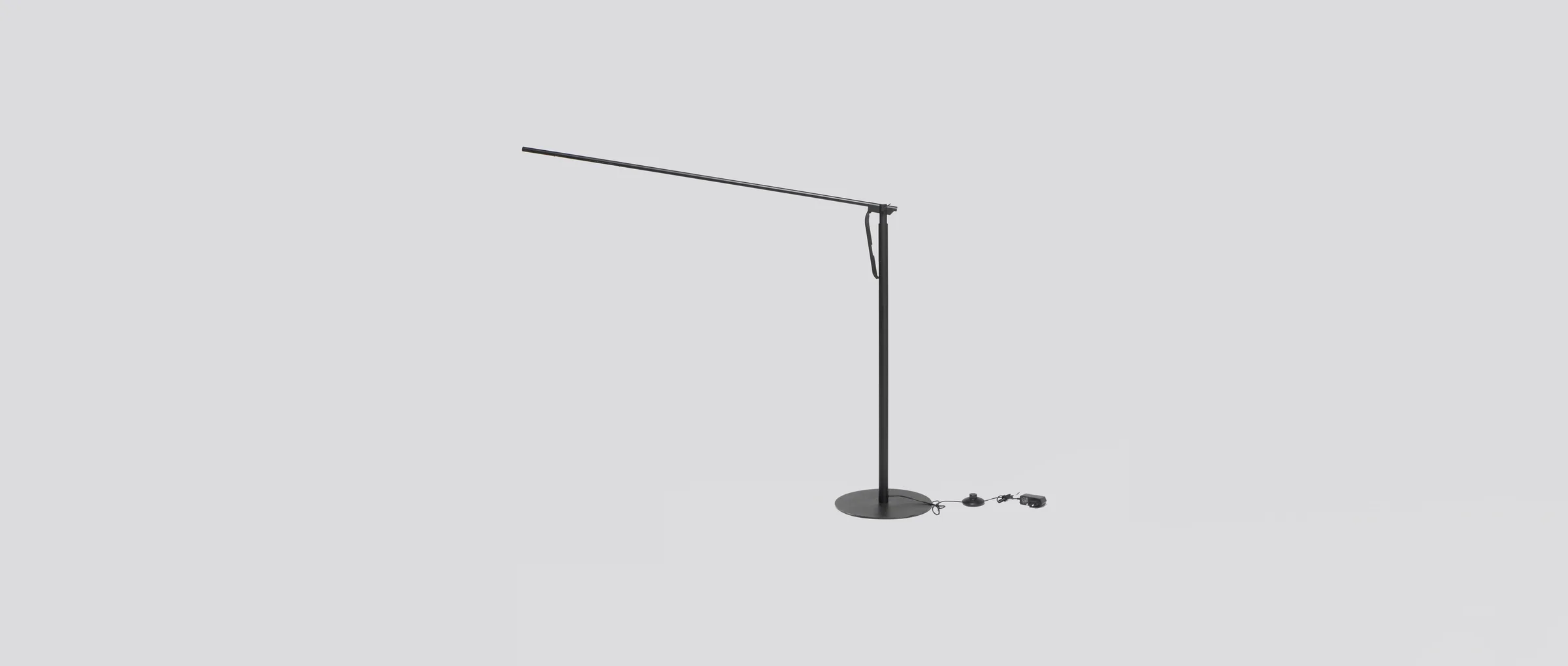 The Calibre floor lamp in full profile, its slender arm reaching wide