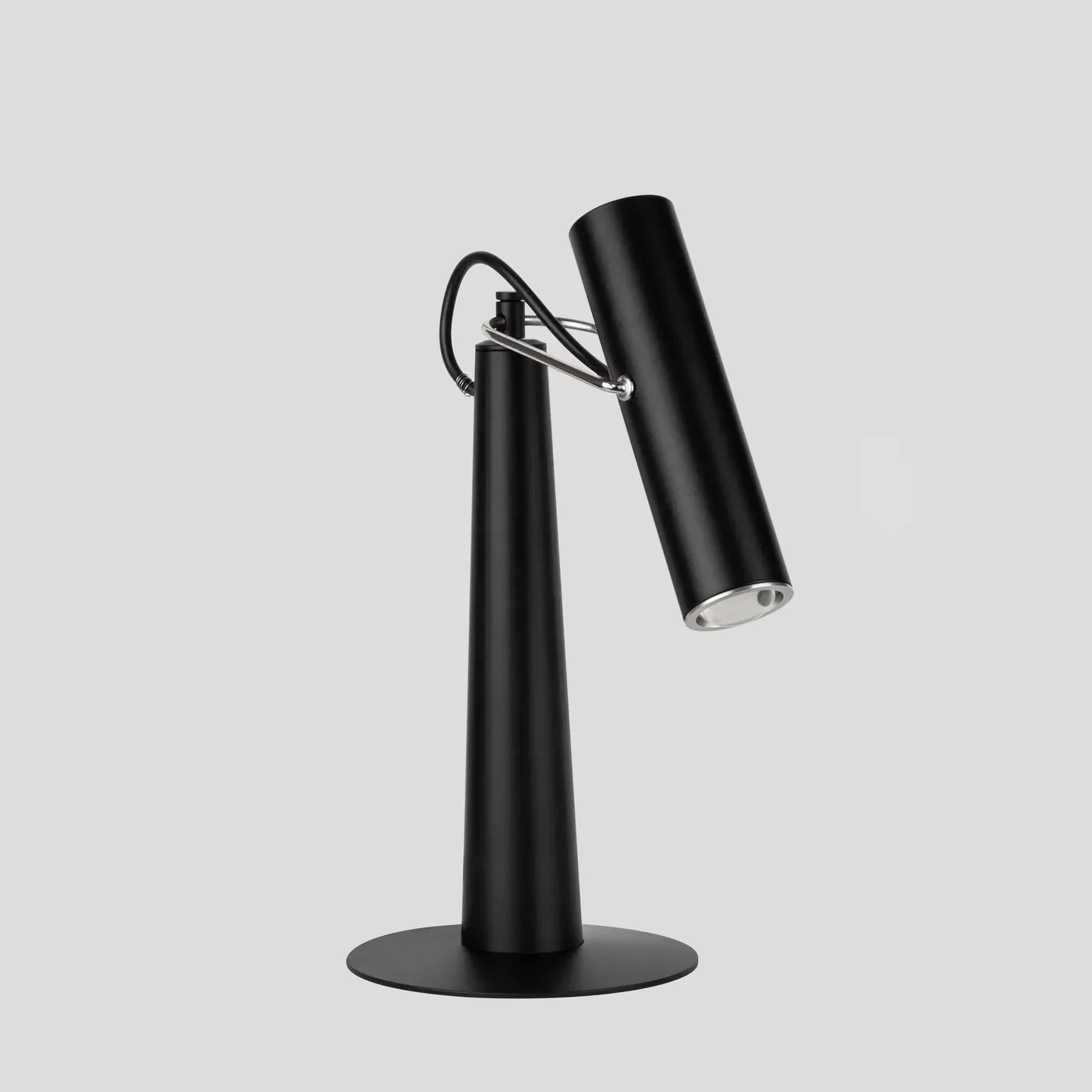Conic in profile, its pivoting cylindrical head catching the light