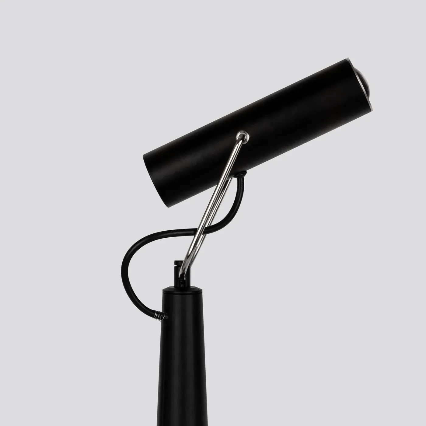 Conic's head rotated low, aiming light across the surface