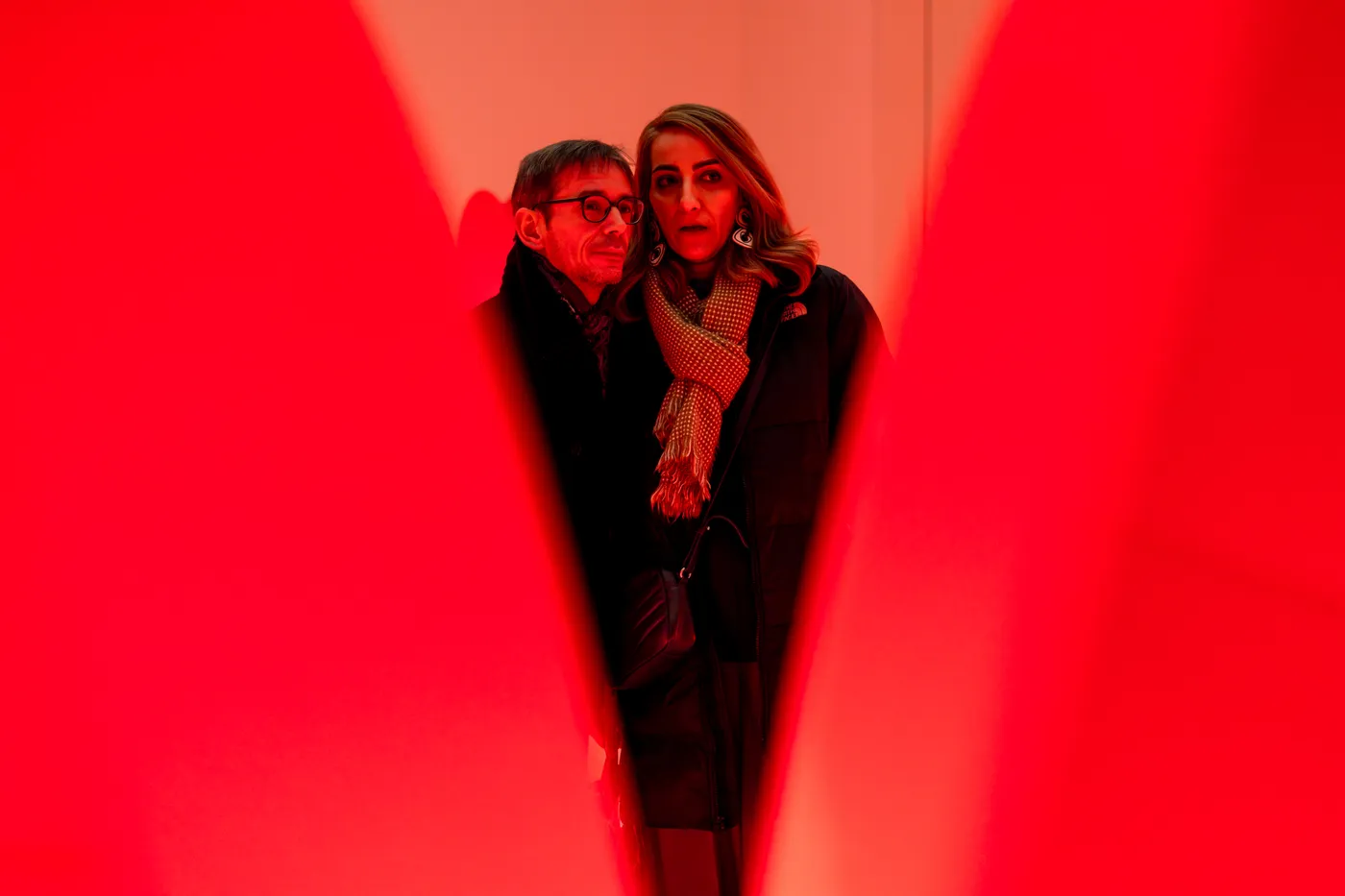 Two visitors framed between the tulip-inspired illuminated forms