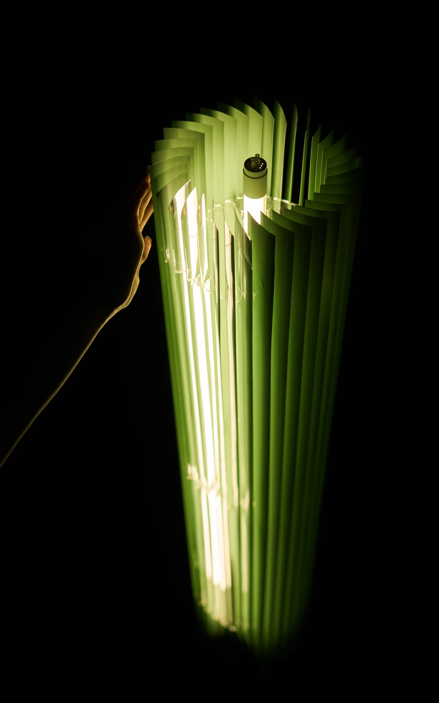 Keker's pleated blades angled against black, lit from within