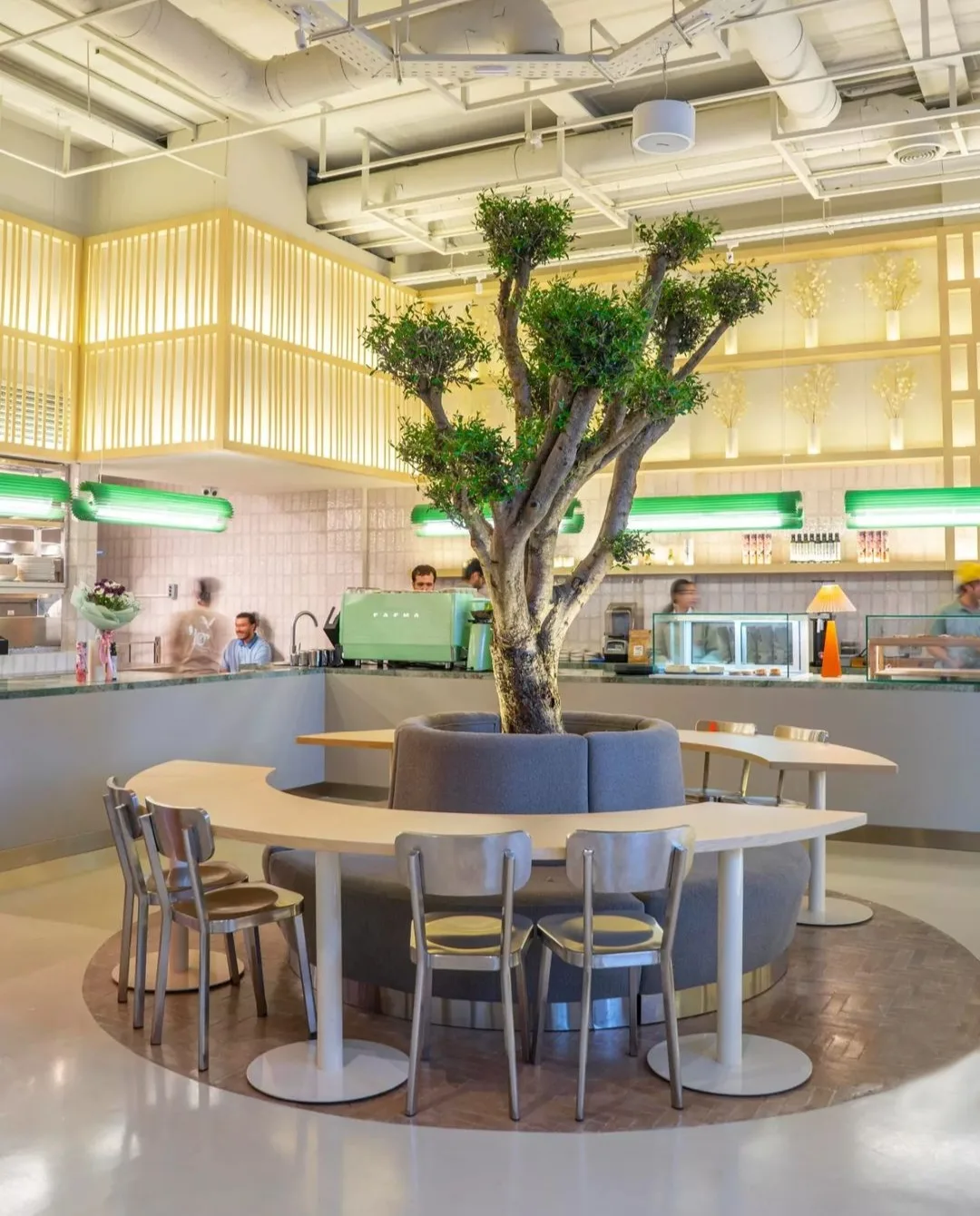 Green Keker pendants running above the counters of a café interior
