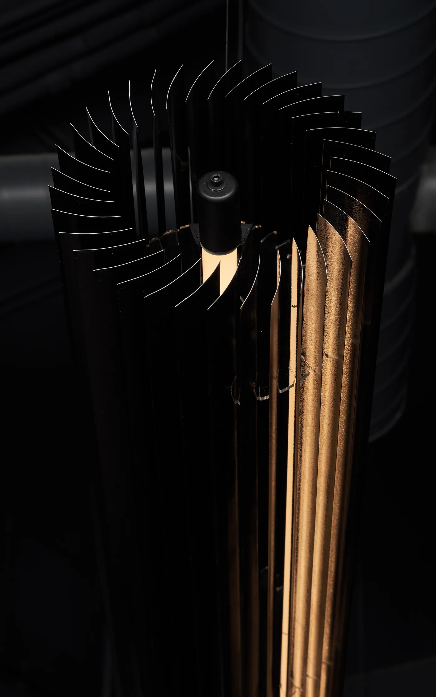 The black Keker from above, its pleated blades spiralling around the light