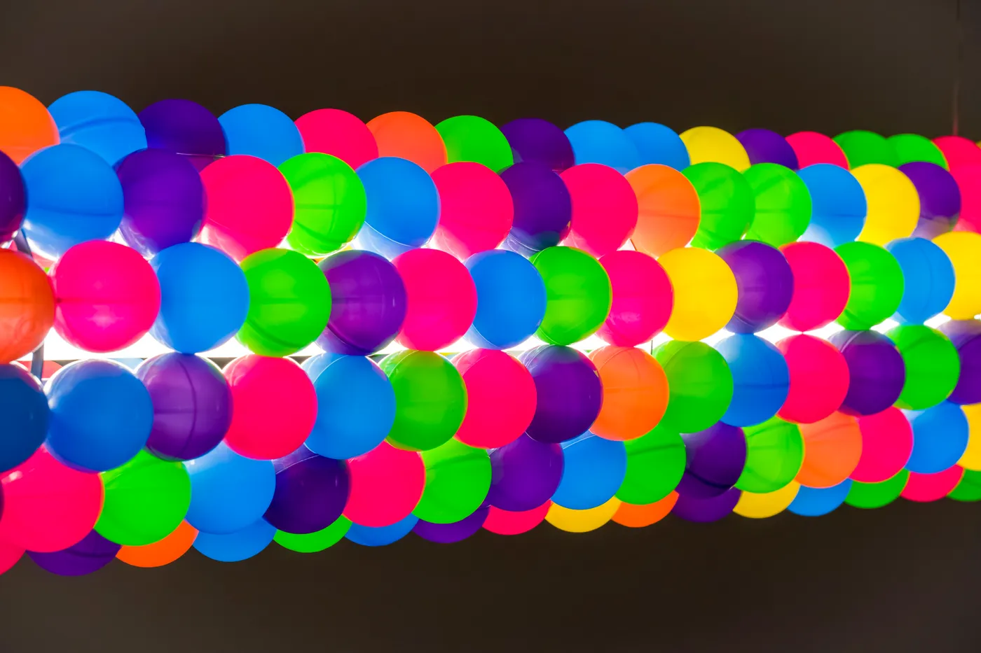Close view of Tooper's colourful ball-clad cylinder, lit