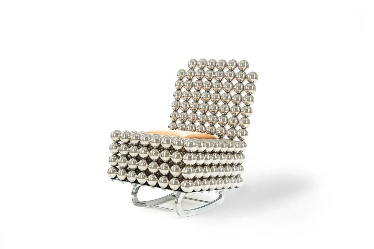 The Wishes rocking chair — chrome spheres cradling a fur cushion