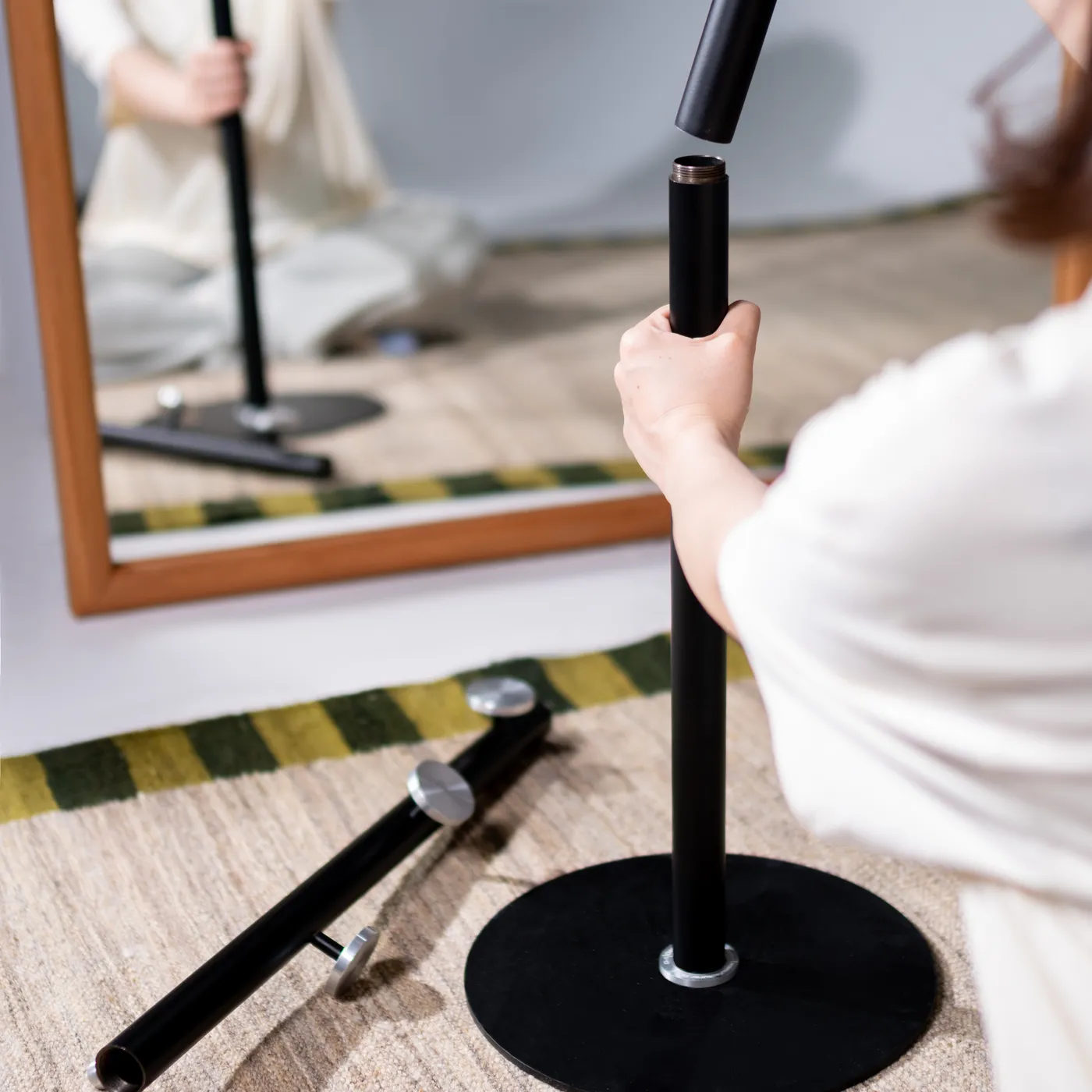 Assembling the rack in front of the mirror